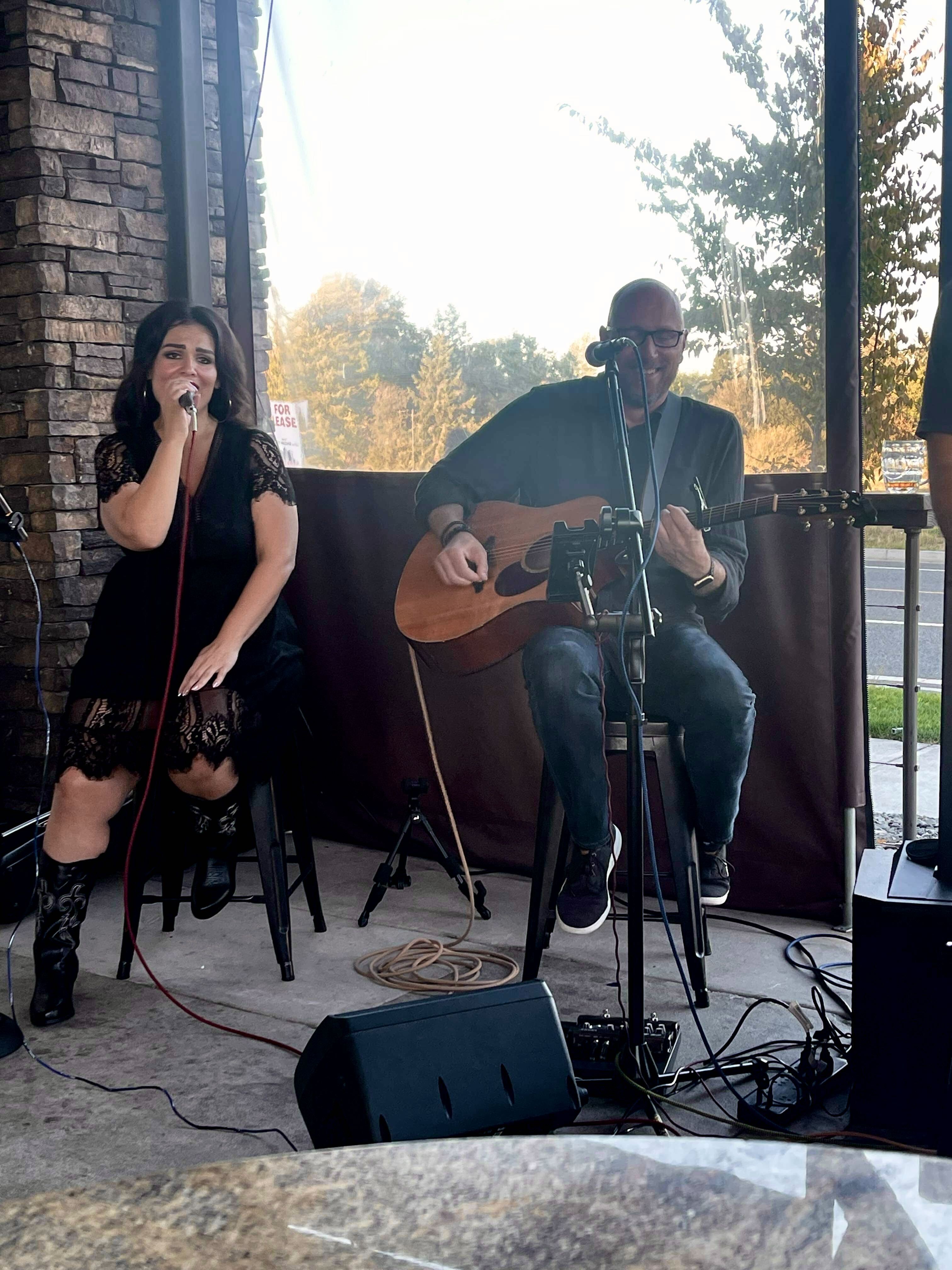 Acoustic Ridge performing on a patio at sunset