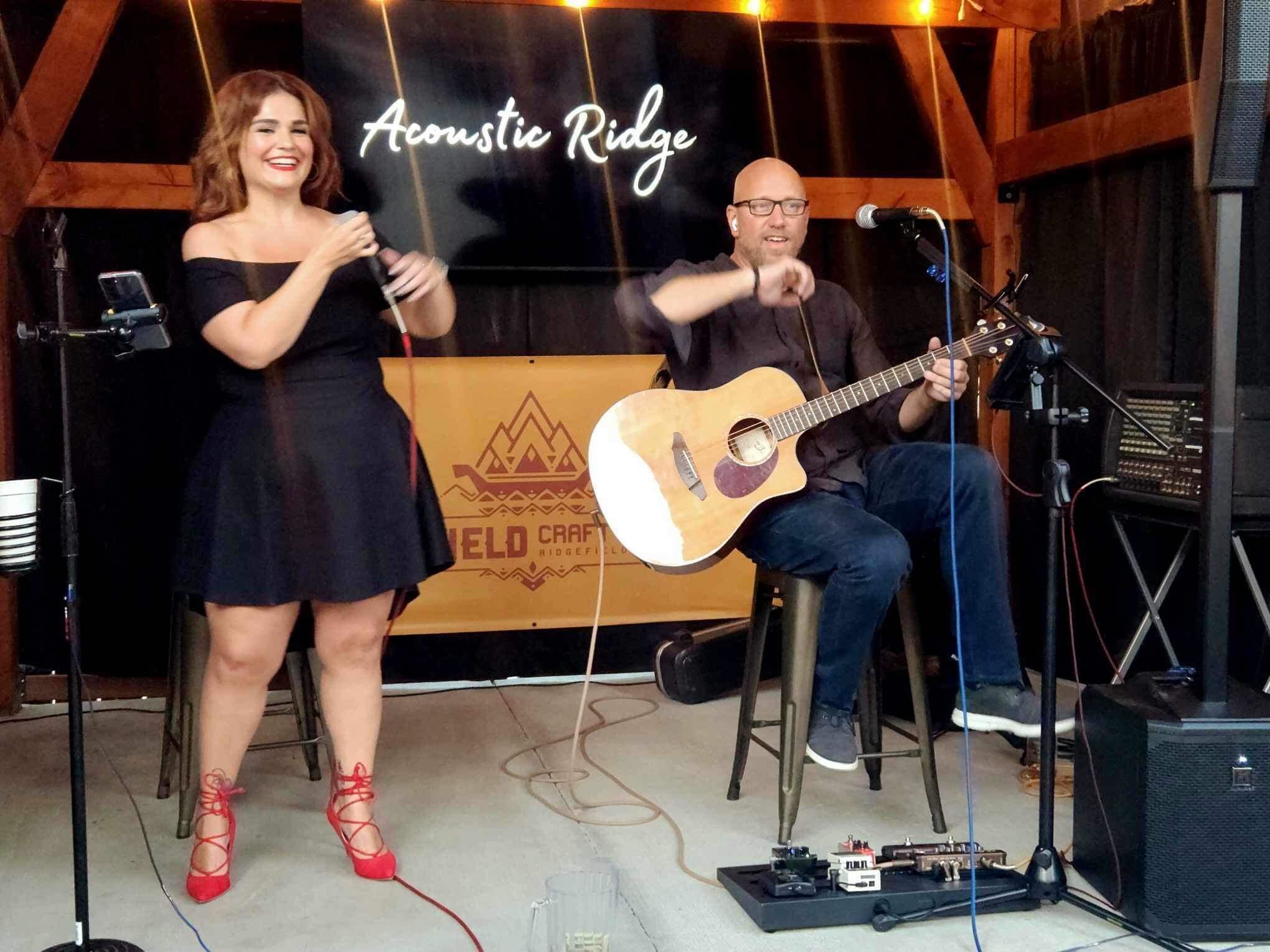 Acoustic Ridge performing under their lit Acoustic Ridge sign at Ridgefield Craft Brewing